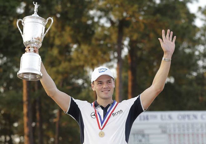 Martin Kaymer, of Germany, holds up the trophy after wining the U.S. Open golf tournament in Pinehurst, N.C., Sunday, June 15, 2014. (AP Photo/Eric Gay)