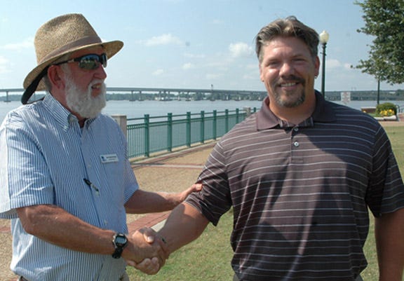 Neuse Riverkeeper Foundation board chairman Jim Kellenberger, left, welcomes new Riverkeeper Travis Graves during a Monday gathering at Union Point Park in New Bern.