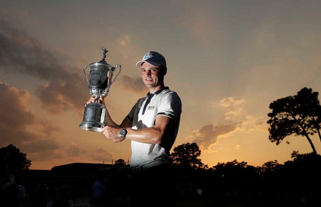 Martin Kaymer, of Germany, poses with the trophy after wining the U.S. Open golf tournament in Pinehurst, N.C., Sunday, June 15, 2014. (AP Photo/Charlie Riedel)