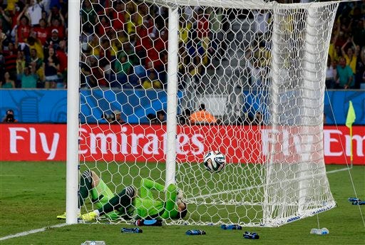 Russia's goalkeeper Igor Akinfeev reacts after letting in the opening goal during the group H World Cup soccer match between Russia and South Korea at the Arena Pantanal in Cuiaba, Brazil, Tuesday.