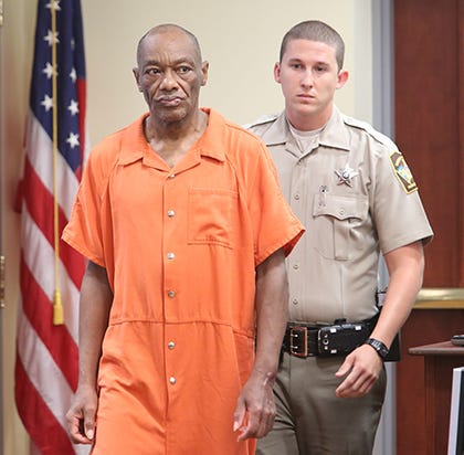 George Evans is escorted into Onslow County Superior Court Friday morning.
