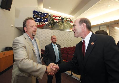 Photo by Daniel Freel/New Jersey Herald - Rep. Scott Garrett, R-5th Dist., right, shakes hands and congratulates artist Art Frisbie on a job well done in painting a mural that honors military veterans during the mural’s official unveiling.