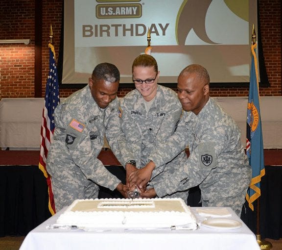 CONTRIBUTED PHOTO/JACKIE GIRARD
Defense Logistics Agency's Senior Enlisted Leader Army Command Sgt. Maj. Sultan Muhammad, Spc. Samantha Griffeth, from Fort Lee's 392nd Army Band, and Army Lt. Col. Linnie Cain, DLA Aviation Customer Operations Directorate's operations officer, cut the cake during DLA Aviation's celebration of the Army's 239th birthday June 9 in the Frank B. Lotts Conference Center on Defense Supply Center Richmond.