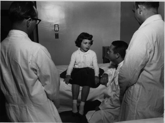 Dr. Richard T. Smith assists the first patient admitted to Shands Hospital in 1958 in this historical photo provided by UF Health Shands Hospital. Dr. Smith has died at age 90.
