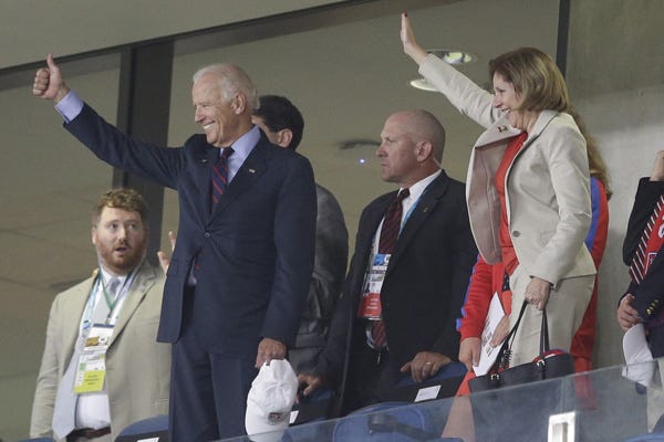 U.S. Vice President Joe Biden, left, gives a thumbs-up after the group G World Cup soccer match between Ghana and the United States at the Arena das Dunas in Natal, Brazil, Monday, June 16, 2014. The United States won the match 2-1. Biden met with team members after their match.