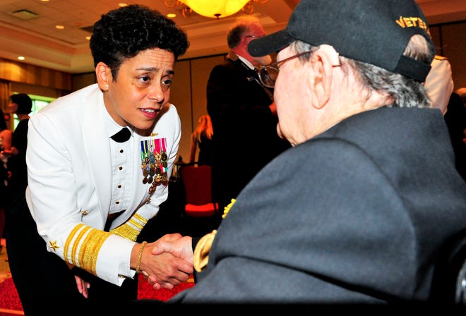 Vice Adm. Michelle Howard, deputy chief of Naval Operations, Plans and Strategy, speaks with Battle of Midway veteran, Wendell Thrasher during the 17th Battle of Midway commemoration dinner at World Golf Village Renaissance Resort in St. Augustine.