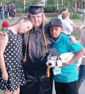 Recent college graduate Melissa Stuart of Reading poses with her two children. 



Courtesy photo