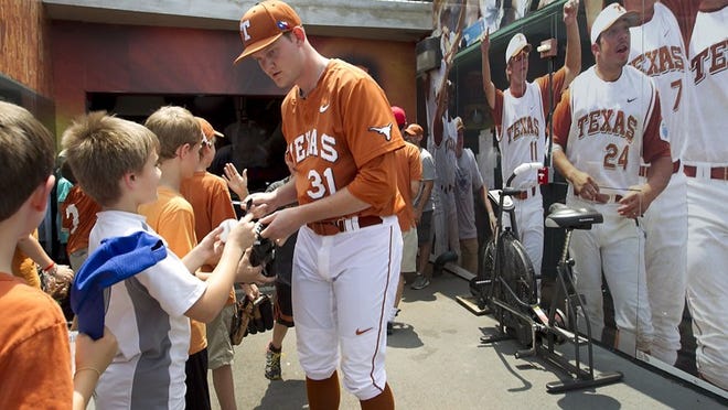 Texas’ Chad Hollingsworth signs autographs for Little Leaguers as he heads to the field before a game with Oklahoma State in April. Hollingsworth, relatively unknown as a relief pitcher, will get the start in Wednesday’s elimination game at the College World Series against UC Irvine.
