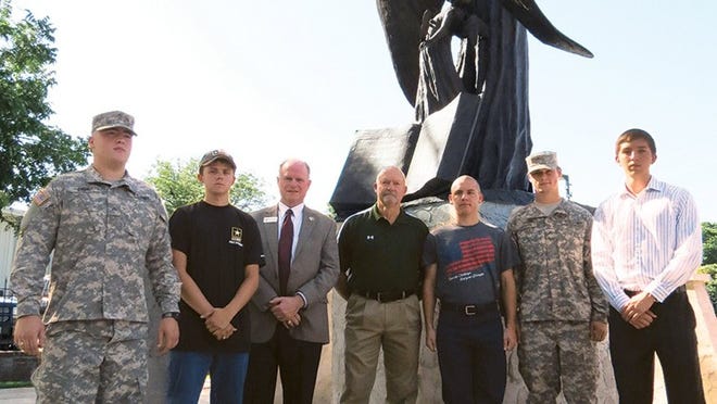 Standing in front of the angel at Smithville Veterans Memorial Park, from left, are Bradley Cook, Dustin Murray, Smithville school district superintendent Rock McNulty, Mayor Mark Bunte, William Stark, John Cowan and Mason Coon.
