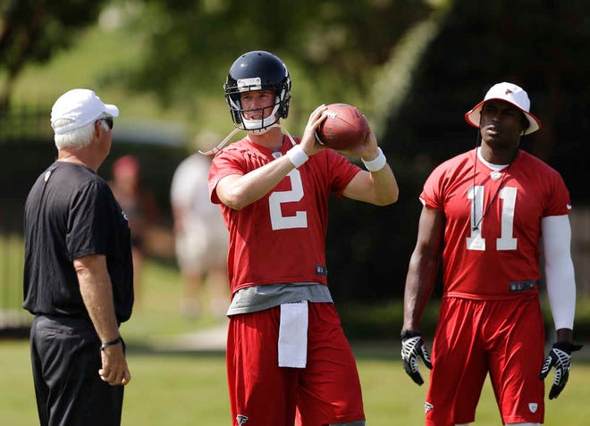 Atlanta Falcons quarterback Matt Ryan, center, talks with head coach Mike Smith, left, while running through a drill with Julio Jones, right, during NFL football minicamp, Thursday, June 19, 2014, in Flowery Branch, Ga. Entering his seventh season as the Falcons' starting quarterback, Ryan says he's comfortable behind a retooled offensive line after last year's 4-12 debacle. Ryan also acknowledges the need to get Atlanta back in the playoffs and show skeptics that he's worth the $113 million contract he signed last July. (AP Photo/David Goldman)