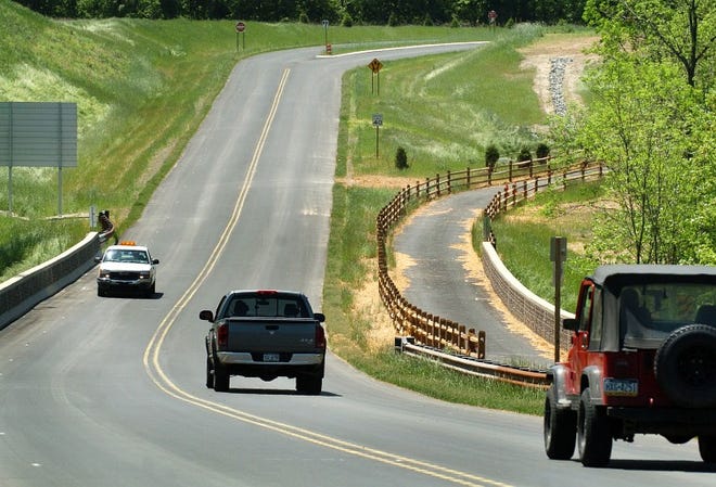 PennDOT workers drive on a stretch of the 202 parkway that travels over Almshouse Road in Doylestown Township in May. The shared-use trail is on the right.