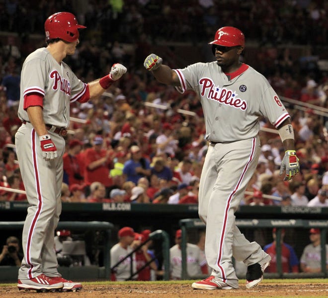 Philadelphia's Ryan Howard (right) is congratulated at home plate by teammate Chase Utley after hitting a two-run home run during the sixth inning Thursday against the Cardinals in St. Louis.