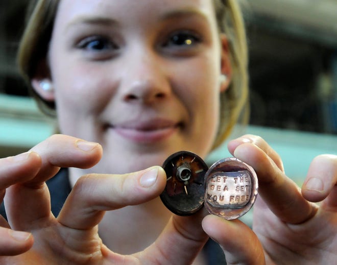 Sophmore Caitlin Brown, 16, of Orleans shows her locket that she is in the process of making from cooper, bronze and brass. Jody Craven teaches metal works at Nauset Regional High School, and the results are professional looking jewelry that is often displayed around Cape Cod.