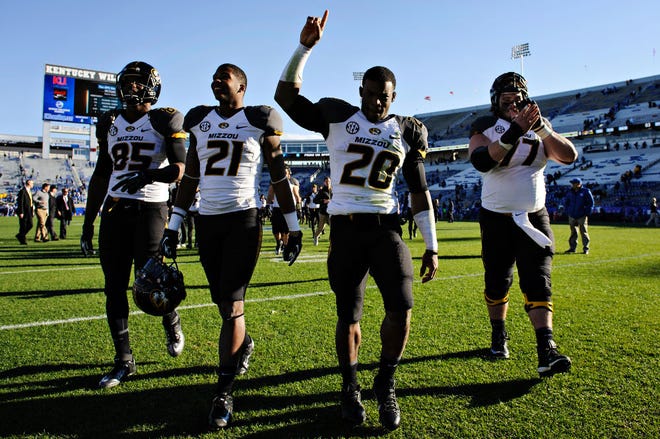 From left, Marcus Lucas, Bud Sasser, Henry Josey and Evan Boehm walk off the field after Missouri won at Kentucky 48-17 on Nov. 9. The Tigers were one of college football’s biggest surprises.