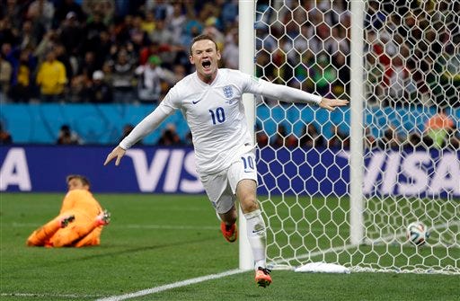 England's Wayne Rooney celebrates after scoring his side's first goal during the group D World Cup soccer match between Uruguay and England at the Itaquerao Stadium in Sao Paulo, Brazil, Thursday.