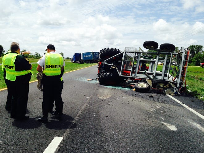 Polk Sheriff's  officials investigate a fatal crash Wednesday on U.S. 27 near the Polk-Highlands County border. A tractor pulling a pesticide sprayer was rear-ended by a tractor-trailer rig.