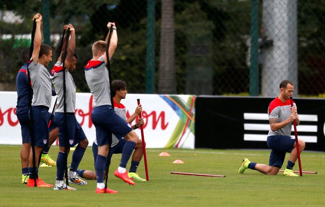 United States' Brad Davis, right, stretches with teammates during a training session in Sao Paulo, Brazil, Thursday, June 19, 2014. The United States will play against Portugal in group G of the soccer World Cup on June 22.