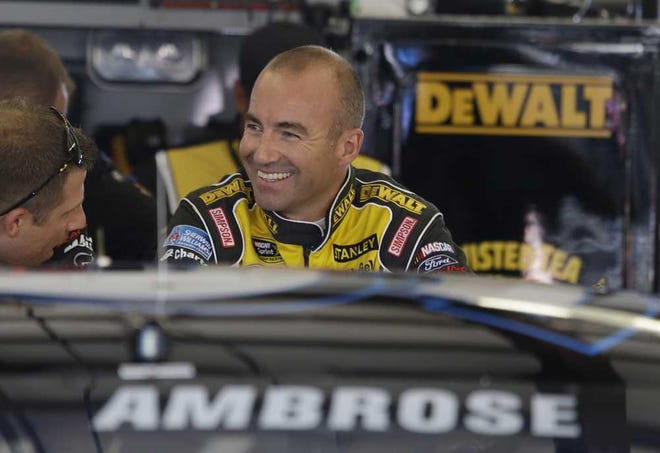 Marcos Ambrose talks with his crew in the garage before the start of practice for the NASCAR Sprint Cup Series auto race Friday, June 20, 2014, in Sonoma, Calif. Ambrose wants nothing more than to break Hendrick Motorsports' four-race winning streak. His best shot comes Sunday on the road course at Sonoma Raceway, where a win could earn the Australian his first berth in the Chase for the Sprint Cup championship. (AP Photo/Eric Risberg)