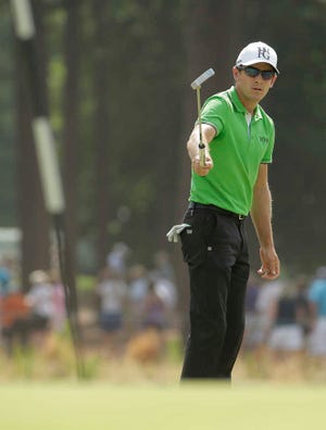 Scott Langley reacts after missing a putt on the 12th hole during the second round of the U.S. Open golf tournament in Pinehurst, N.C., Friday, June 13, 2014. (AP Photo/Charlie Riedel)