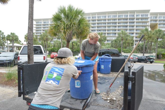 Americorp volunteer, Jacob Shields and Choctawhatchee Basin Alliance (CBA) employee, Rachel Gwin load bins of shucked oysters into a truck to be used in the oyster recycling program.