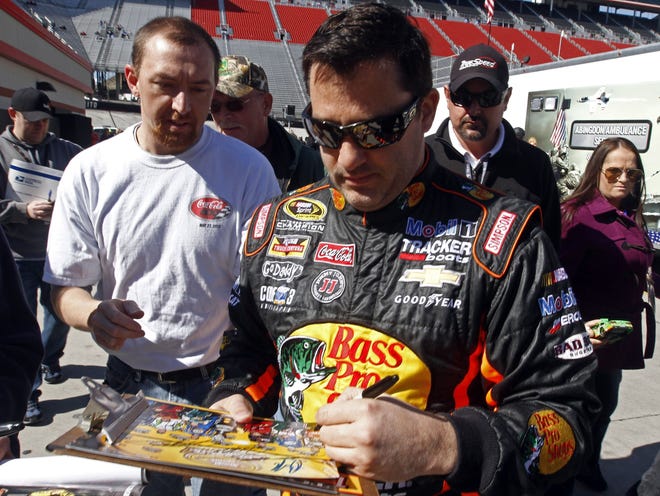 Tony Stewart (14) signs autographs before practice for the NASCAR Sprint Cup Series race March 14 at Bristol (Tenn.) Motor Speedway.