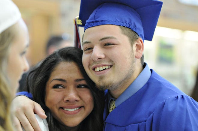 CB East's Brianna Williams looks over to friends after shedding tears with classmate Max Strassel as they gather for one last time before the school's 45th Commencement in Buckingham Friday. This year CB East handed out 565 diplomas to the student body.