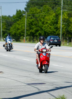 A Moped travels down U.S. 17 south in Jacksonville on Thursday afternoon. The N.C. House of Representatives this week approved a bill to authorize annual registration and tags for mopeds, and initiate a study into the feasibility of insurance requirement for the unlicensed drivers.