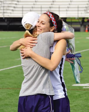 Ryan O’Leary photo 
Exeter High School graduate Kim Arkell hugs lacrosse coach Courtney Preneta during Senior Day last month. Arkell was named first-team All-State and All-American honorable mention by the NHFL on Monday. She was one of Exeter’s six honorees.