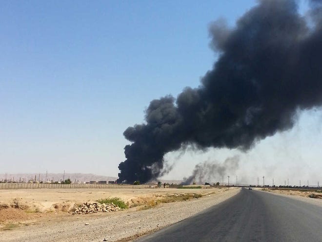 A column of smoke rises from an oil refinery in Beiji, some 250 kilometers (155 miles) north of Baghdad, Iraq, Thursday, June 19, 2014. The fighting at Beiji comes as Iraq has asked the U.S. for airstrikes targeting the militants from the Islamic State of Iraq and the Levant. While U.S. President Barack Obama has not fully ruled out the possibility of launching airstrikes, such action is not imminent in part because intelligence agencies have been unable to identify clear targets on the ground, officials said. (AP Photo)