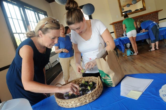 Lisa and Erin Cunningham put the finishing touches on their Blueberry Mojito Pie Squares on Friday at the N.C. Blueberry Festival Recipe Contest in Burgaw.