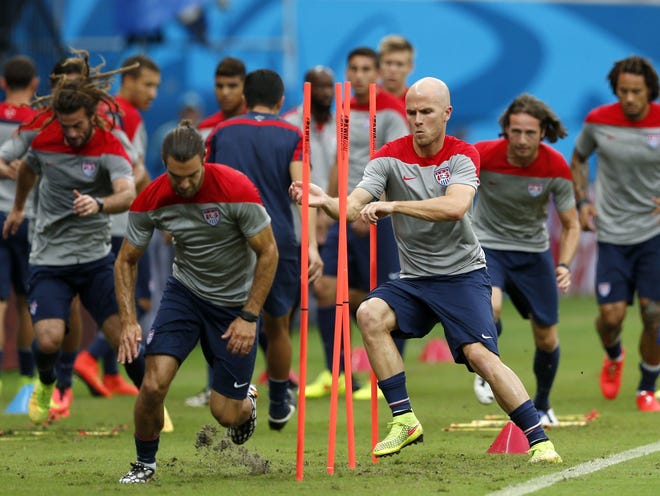 The United States' Michael Bradley, center left, runs through obstacles with teammates during a training session Saturday at the Arena da Amazonia in Manaus, Brazil.