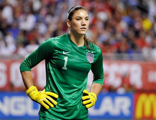 In this Oct. 20, 2013, file photo, United States goalkeeper Hope Solo pauses on the field during the second half of an international friendly women's soccer match against Australia in San Antonio. Police say Solo has been arrested early Saturday, June 21, 2014, at a suburban Seattle home for assaulting her sister and nephew.