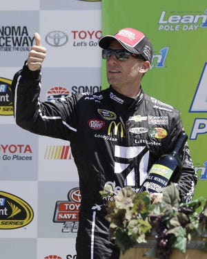 Jamie McMurray gives a thumbs up during the awards presentation to the pole winner after qualifying for the NASCAR Sprint Cup Series auto race Saturday, June 21, 2014, in Sonoma, Calif. (AP Photo/Eric Risberg)