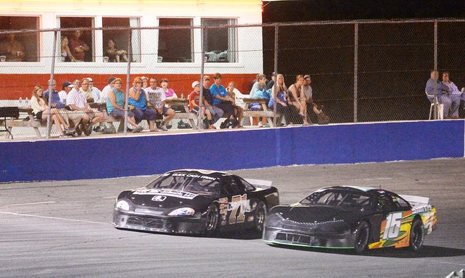 R.D. Smith, right, passes Dean Fogleman for the lead in the Late Models race Friday night at Ace Speedway.