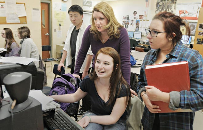 (file) Neshaminy High School student newspaper adviser and English teacher Tara Huber (center standing) works with students during a newspaper production class in March