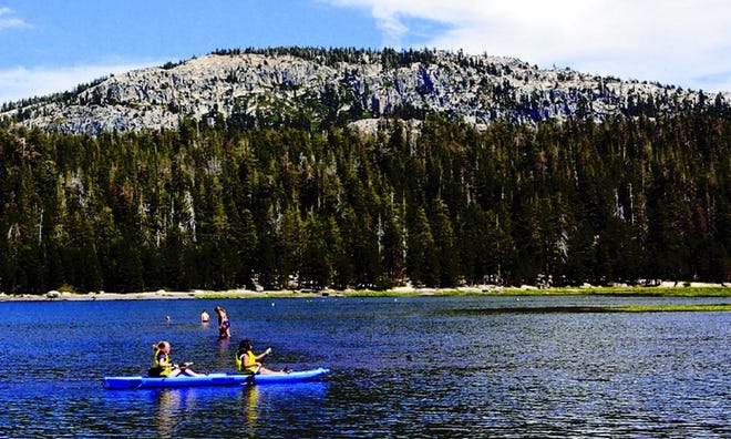 Campers kayak at Silver Lake Stockton Camp, which has been a beloved summer tradition for local families since 1921.