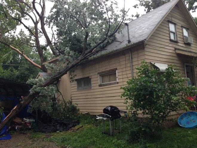 Jason Kerley, 37, was outside his home at 500 S.E. Kouns when gusts blew through Topeka on Sunday evening. The winds blew down a large tree branch, cutting off power and creating a hole in his roof. Emergency crews spent hours Sunday responding to similar calls resulting from a brief but damaging storm.