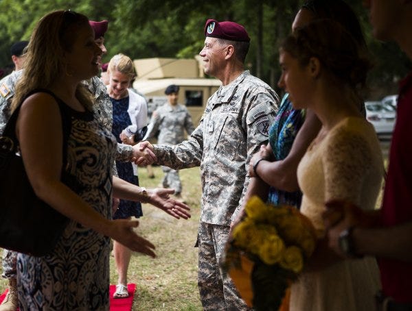 Brig. Gen. Daniel Ammerman, center, and his family greet well-wishers on Fort Bragg after a change of command ceremony Sunday.