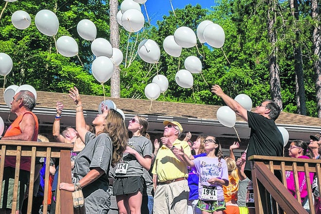 People release balloons Saturday to honor their loved ones at the Lap 4 Life Race in Newburgh.
