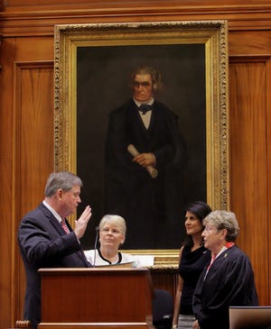 South Carolina state Sen. Yancey McGill is sworn in as interim lieutenant governor by state Supreme Court Justice Jean Toal on Wednesday. Watching are McGill's wife, Pam, and Gov. Nikki Haley.