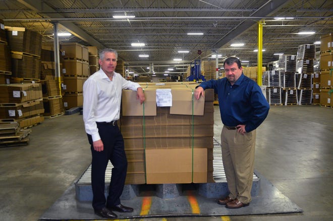 Coastal Container President Bill Bamgartner, left, and CEO Paul Doyle lead a $40-million operation on Holland's south side. The company is poised to double the size of its workforce within the next two years. Andrew Whitaker/Sentinel Staff
