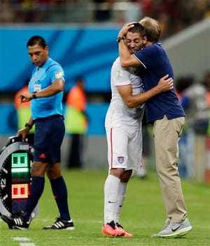 United States' head coach Juergen Klinsmann hugs United States' Clint Dempsey during the group G World Cup soccer match between the United States and Portugal at the Arena da Amazonia in Manaus, Brazil, Sunday. The United States and Portugal tied 2-2.