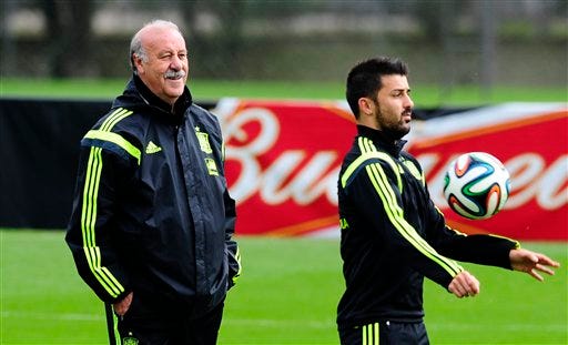 Spain's head coach Vicente del Bosque left, looks on, as David Villa controls the ball during a training session at the Atletico Paranaense training center in Curitiba, Brazil, Friday. Spain play in group B of the Brazil 2014 World Cup.