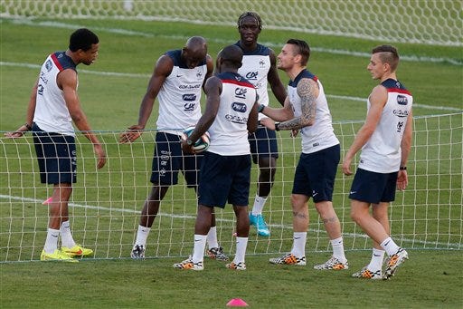 Players of the French national soccer team, from left, Loic Remy, Eliaquim Mangala, Rio Mavuba, Bakary Sagna, Mathieu Debuchy and Lucas Digne play tennis-ball during a training session at the Santa Cruz stadium in Ribeirao Preto, Brazil, Sunday, June 22, 2014. Having captured people's attention at the soccer World Cup with some scintillating attacking football, France's players are now in unknown territory after raising expectations back home, having routed Switzerland and Honduras.