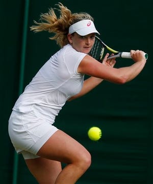 Coco Vandeweghe of the U.S. plays a return to Garbine Muguruza of Spain during their first round match at the All England Lawn Tennis Championships in Wimbledon, London, Monday, June 23, 2014.