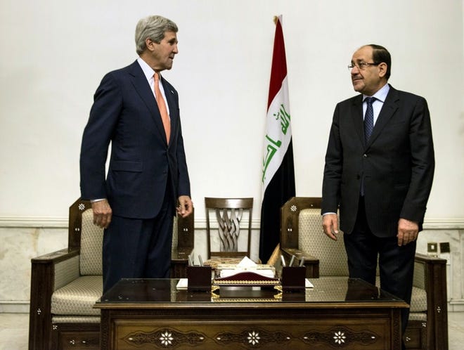 U.S. Secretary of State John Kerry, left, meets with Iraqi Prime Minister Nouri al-Maliki on Monday at the Prime Minister's office in Baghdad. Kerry met with Iraqi leaders and urged the Shiite-led government to give more power to political opponents.