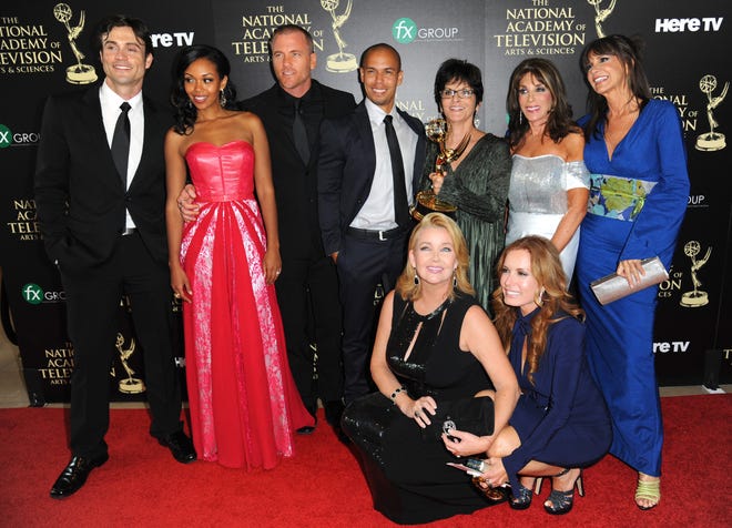 The cast and crew of “The Young and the Restless” poses in the press room with the award for outstanding drama series at the 41st annual Daytime Emmy Awards at the Beverly Hilton Hotel on Sunday in Beverly Hills, Calif. (Photo by Richard Shotwell/Invision/AP)