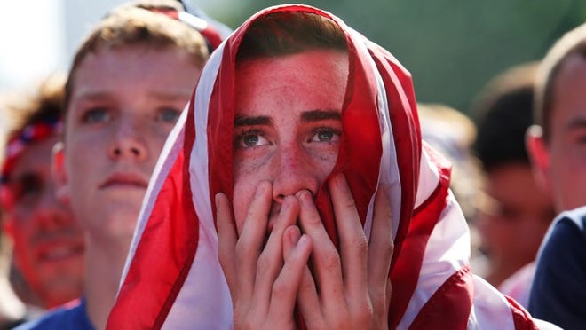 Patrick Roder, a 21-year-old U.S. soccer fan, follows the American team’s World Cup match against Portugal on Sunday during a watch party at Grant Park in Chicago. The Yanks surrendered a 2-1 lead by allowing a last-minute goal and had to settle for a draw. CREDIT: Chandler West/AP Photo/Sun-Times Media