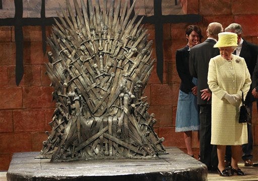 Britain's Queen Elizabeth visits the throne room at the set of the Game of Thrones TV series in Titanic Quarter, in Belfast Northern Ireland, Tuesday, June, 24, 2014. The Queen is on a 3 day visit to Northern Ireland. (AP Photo/Peter Morrison)