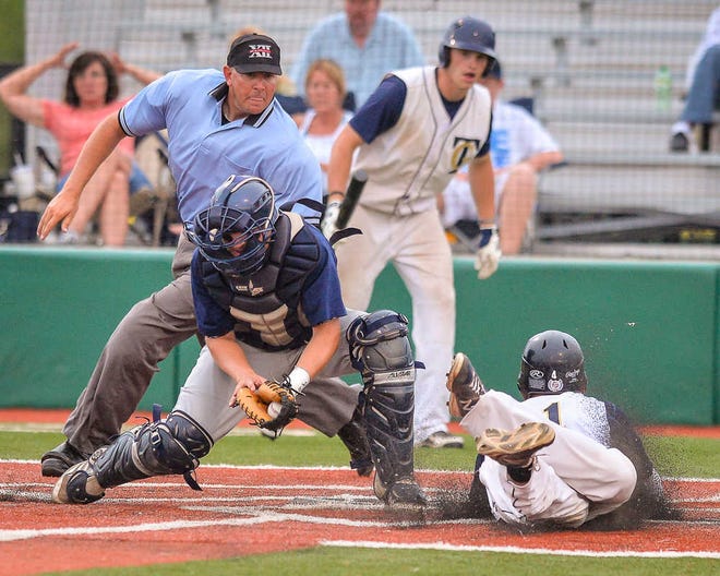Golden Giants #31 Connor Crimmins slides safely into home plate as the Golden Giants take the lead Tuesday evening